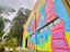 Artista Carol Lemes realizou a pintura da fachada dos Estúdios do Curso de Cinema e Audiovisual na Sede Boqueirão